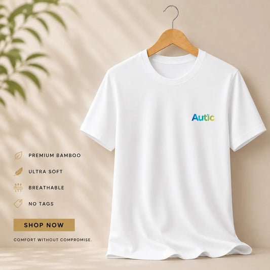 White Autic sensory friendly bamboo T shirt on a hanger, featuring ultra soft, breathable fabric with no tags.